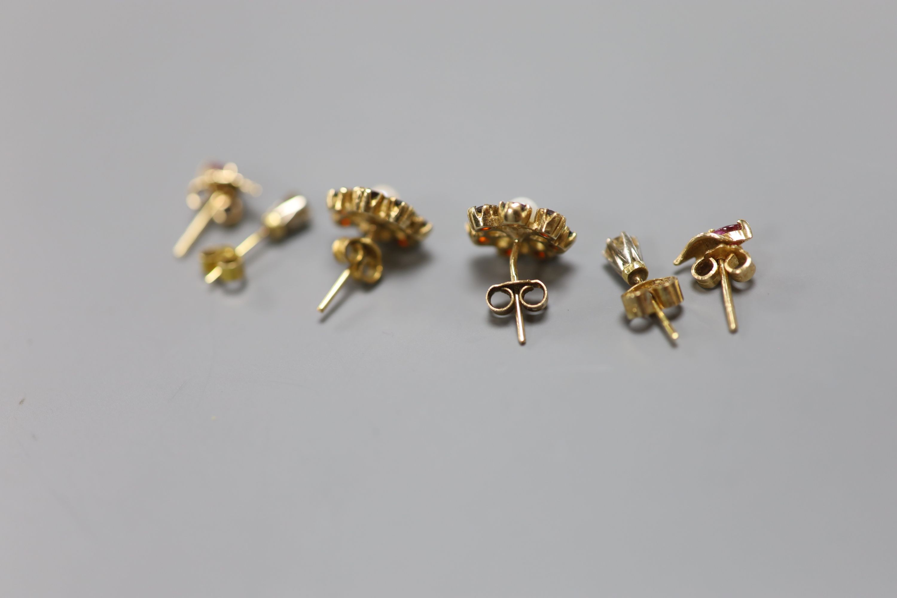 A pair of diamond stud earrings and two other pairs of stud earrings